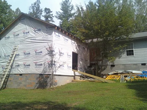 Tyvek wrapped gable on a new room addition beside an existing home in Ashland